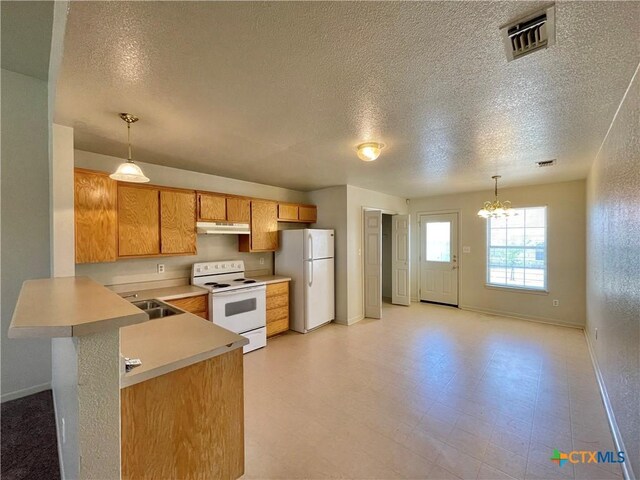 3805 Uvalde Dr, Killeen, TX 76549 - kitchen with white appliances, a textured ceiling, light countertops, baseboards, and a chandelier