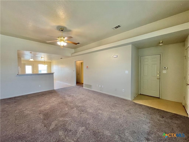 3805 Uvalde Dr, Killeen, TX 76549 - unfurnished living room with carpet flooring, a ceiling fan, and baseboards