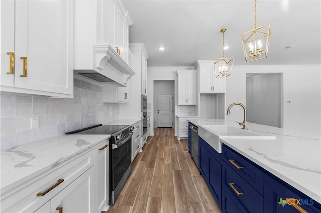 kitchen with white cabinets, light wood finished floors, a sink, electric range oven, and blue cabinetry