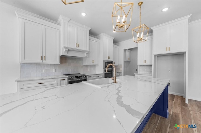 kitchen featuring backsplash, white cabinetry, stainless steel appliances, and custom range hood