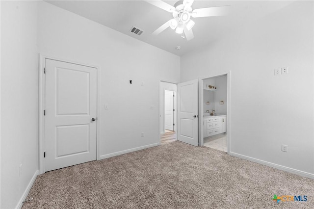unfurnished bedroom featuring visible vents, baseboards, light carpet, and connected bathroom