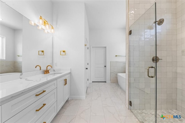 bathroom with a shower stall, a soaking tub, marble finish floor, and vanity