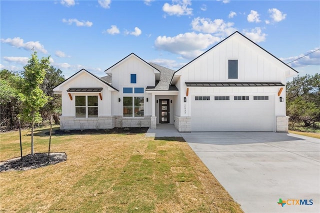 modern farmhouse style home featuring a front lawn, stone siding, board and batten siding, an attached garage, and a standing seam roof