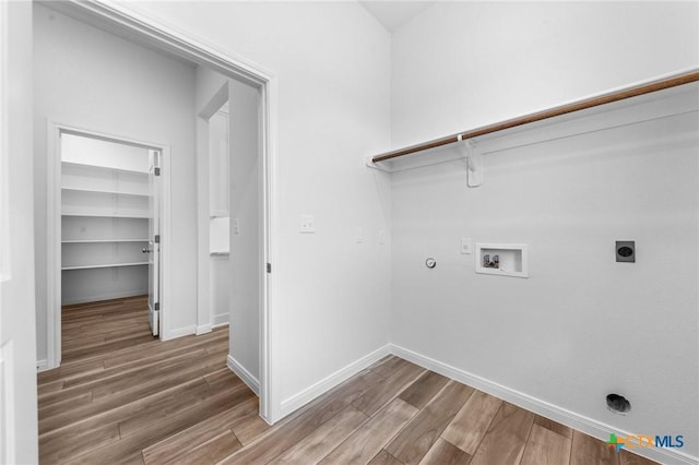 washroom with laundry area, wood finished floors, gas dryer hookup, hookup for a washing machine, and electric dryer hookup