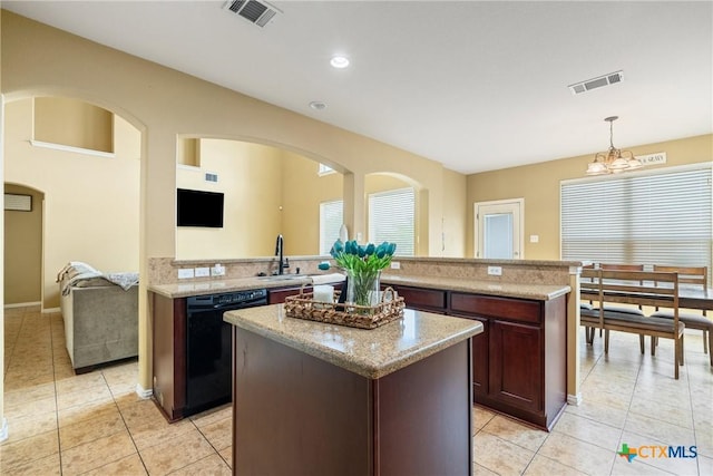 1002 Wallin Farms Cv, Hutto, TX 78634 - kitchen with dishwasher, light tile patterned floors, a kitchen island, plenty of natural light, and recessed lighting