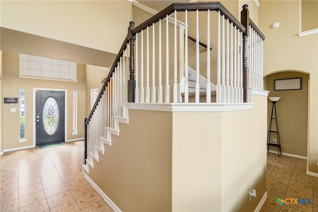 1002 Wallin Farms Cv, Hutto, TX 78634 - tiled entrance foyer with stairway and a towering ceiling