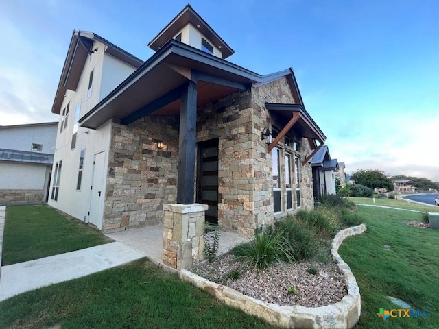 view of side of home featuring a lawn