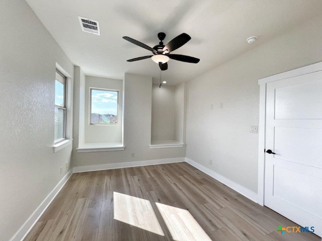 empty room featuring light wood-type flooring and ceiling fan