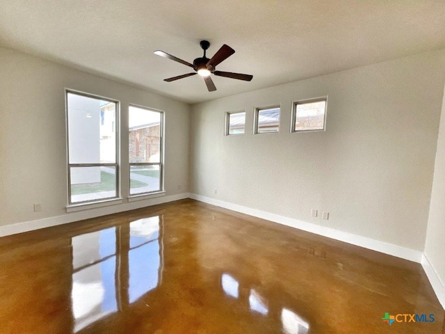 spare room with concrete flooring, a textured ceiling, and ceiling fan