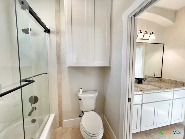 full bathroom with tile patterned flooring, vanity, combined bath / shower with glass door, and toilet