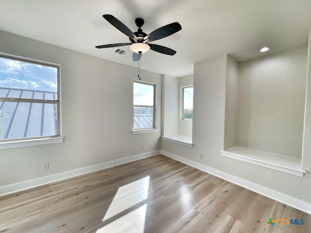 unfurnished room with light hardwood / wood-style flooring and ceiling fan