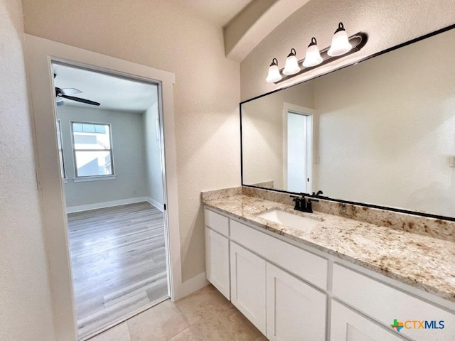 bathroom featuring wood-type flooring, ceiling fan, and vanity