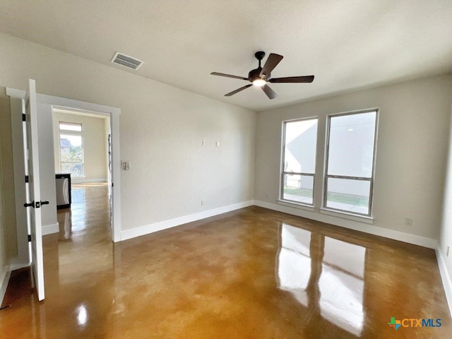 empty room featuring concrete flooring and ceiling fan