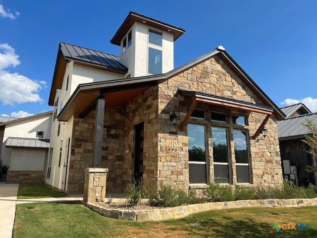 view of side of home with a lawn