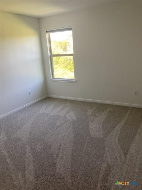 unfurnished room featuring baseboards and carpet floors