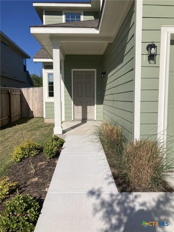 view of exterior entry with fence