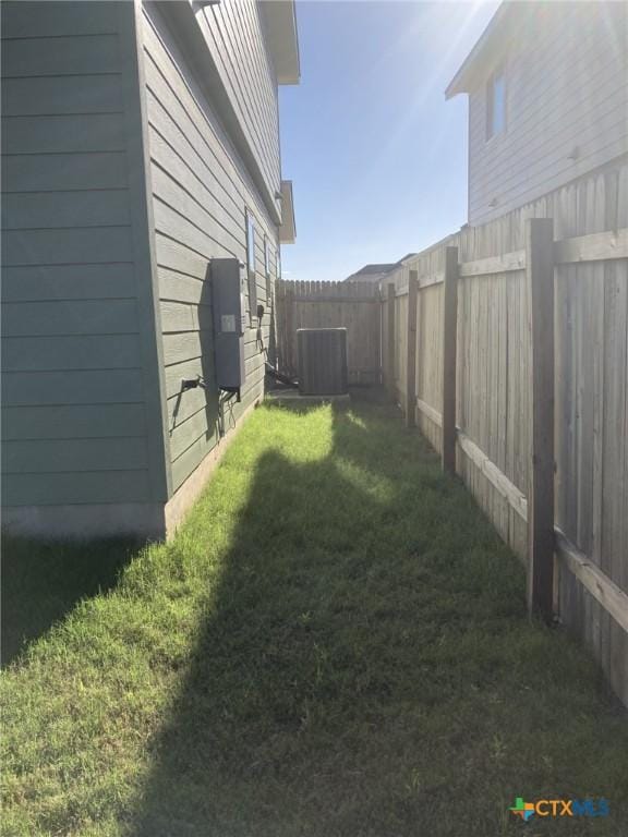 view of yard featuring central AC and a fenced backyard