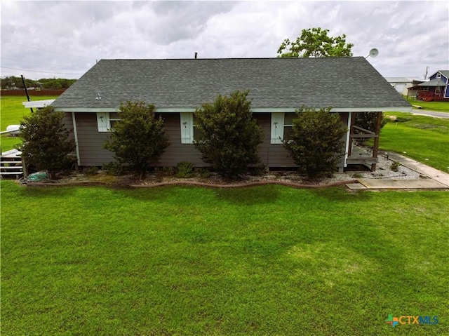 1403 Bill Tindall Ave, Seadrift, TX 77983 - view of front of house featuring roof with shingles and a front lawn
