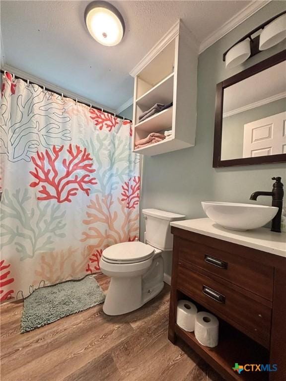 1403 Bill Tindall Ave, Seadrift, TX 77983 - full bath featuring crown molding, wood finished floors, toilet, vanity, and a shower with shower curtain