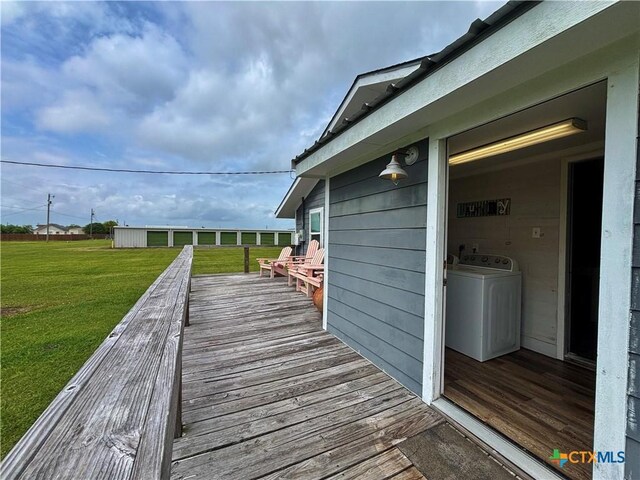 1403 Bill Tindall Ave, Seadrift, TX 77983 - wooden deck featuring washer / clothes dryer and a lawn