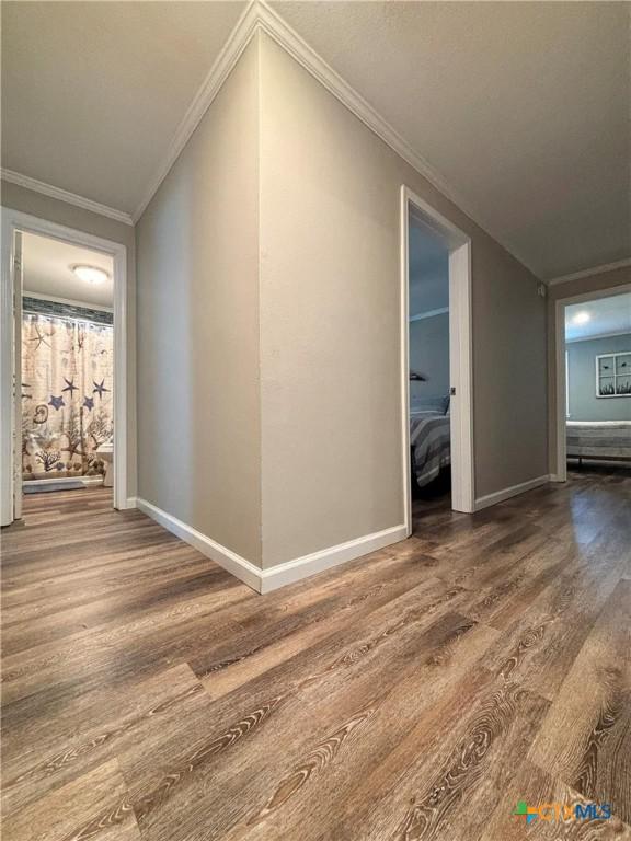 1403 Bill Tindall Ave, Seadrift, TX 77983 - hall featuring wood finished floors, baseboards, and crown molding