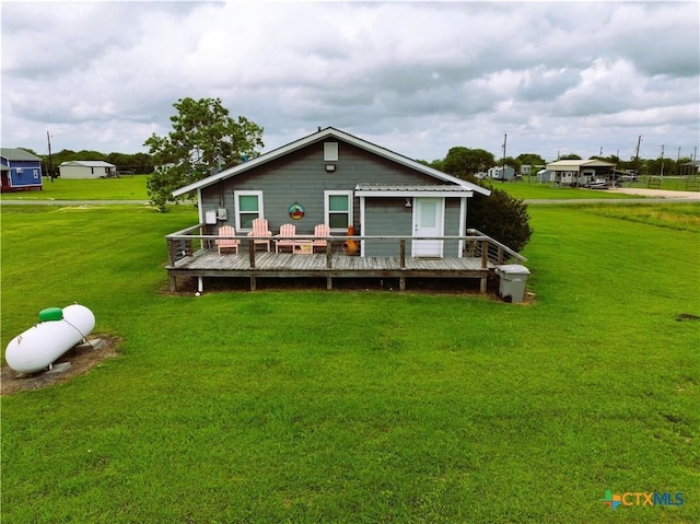 1403 Bill Tindall Ave, Seadrift, TX 77983 - back of house featuring a wooden deck and a yard