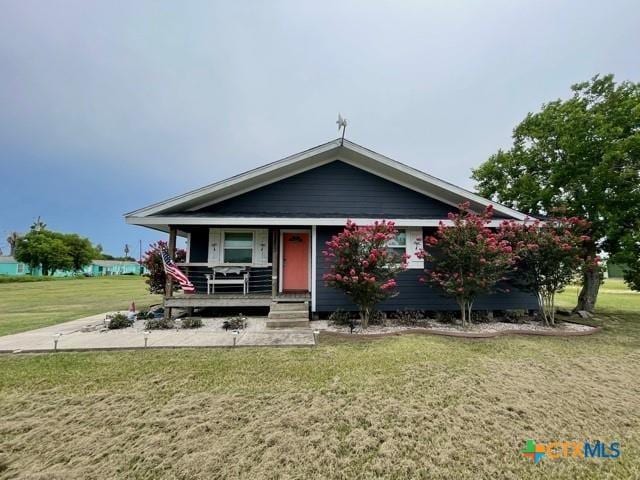 1403 Bill Tindall Ave, Seadrift, TX 77983 - view of front of house featuring covered porch and a front yard