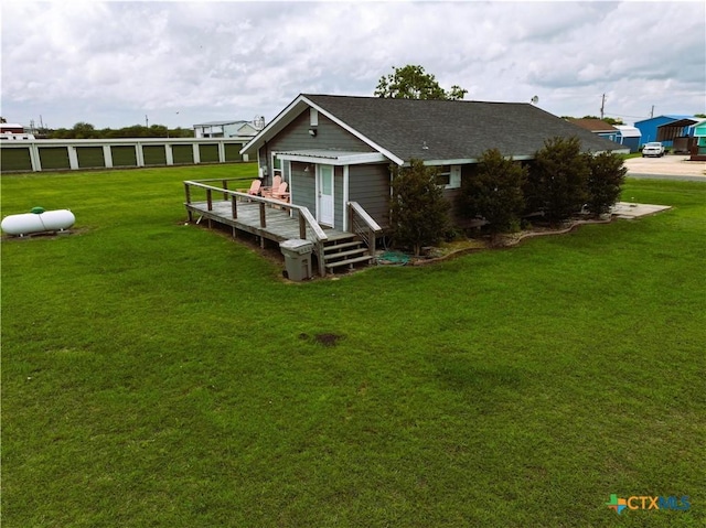 1403 Bill Tindall Ave, Seadrift, TX 77983 - back of property with a deck, a lawn, and a shingled roof