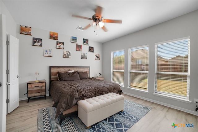 bedroom with light wood-type flooring and ceiling fan