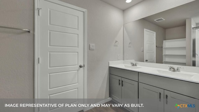 bathroom featuring double vanity, baseboards, visible vents, and a sink