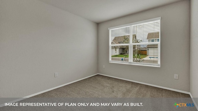 carpeted empty room featuring baseboards