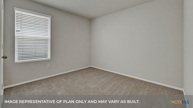 spare room featuring carpet floors and baseboards