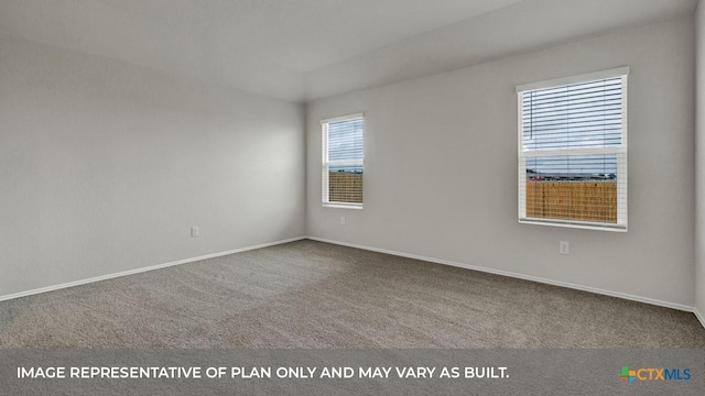 unfurnished room with carpet flooring and baseboards