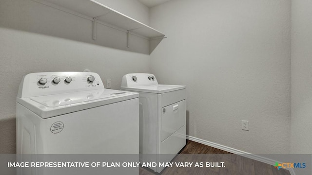 laundry area featuring a textured wall, laundry area, dark wood finished floors, baseboards, and washing machine and clothes dryer