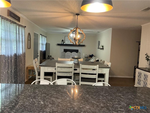 208 Old Fort Gates Rd, Gatesville, TX 76528 - dining space with crown molding, wood finished floors, a chandelier, baseboards, and a textured ceiling