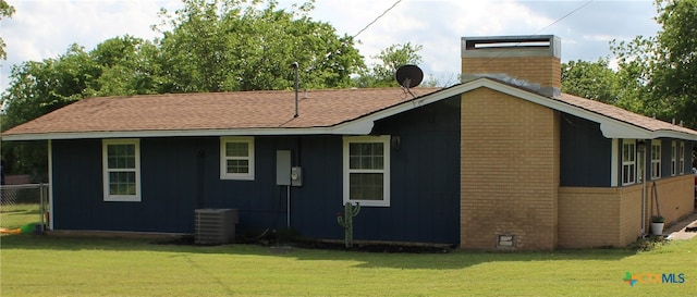 208 Old Fort Gates Rd, Gatesville, TX 76528 - back of house featuring brick siding, central air condition unit, a yard, and a chimney
