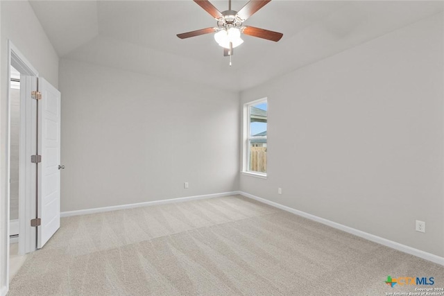 spare room featuring light colored carpet and ceiling fan