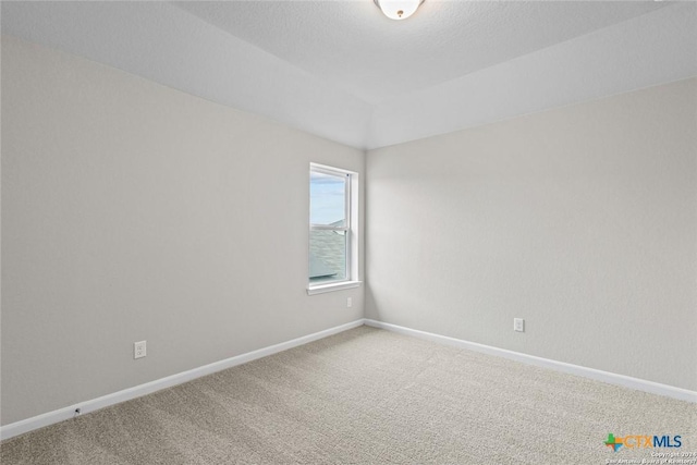 carpeted spare room with a textured ceiling