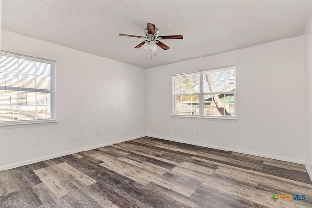 spare room featuring a textured ceiling, plenty of natural light, wood finished floors, and ceiling fan