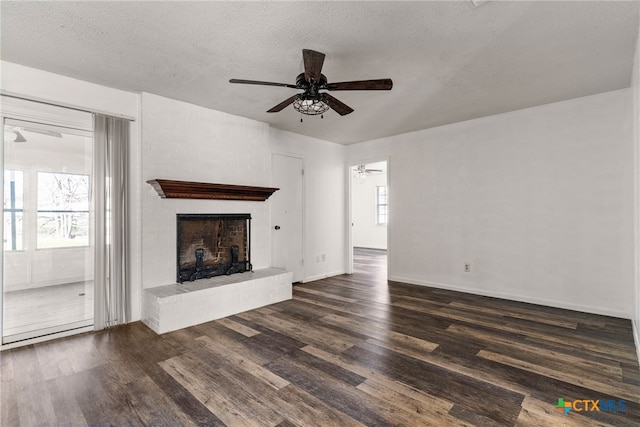 unfurnished living room featuring plenty of natural light, a textured ceiling, ceiling fan, and dark wood-style flooring