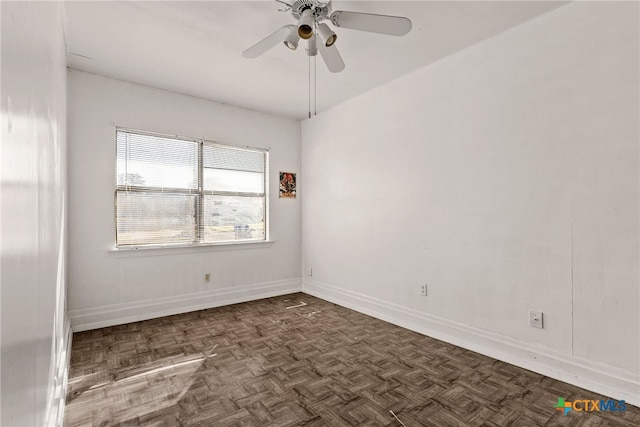 spare room with baseboards and a ceiling fan