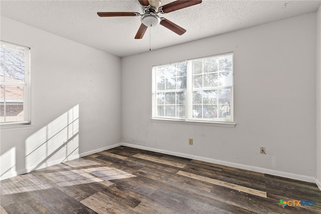 spare room featuring ceiling fan, baseboards, a textured ceiling, and dark wood-style floors