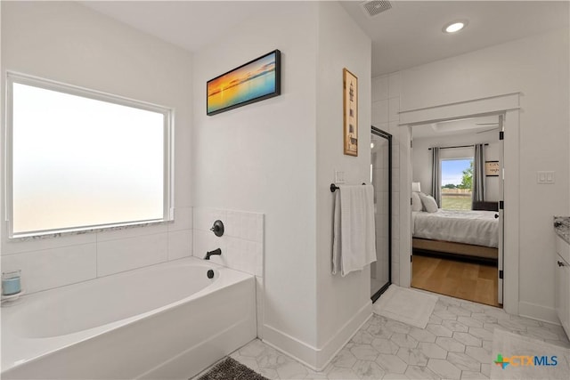 full bath featuring visible vents, connected bathroom, baseboards, walk in shower, and a garden tub