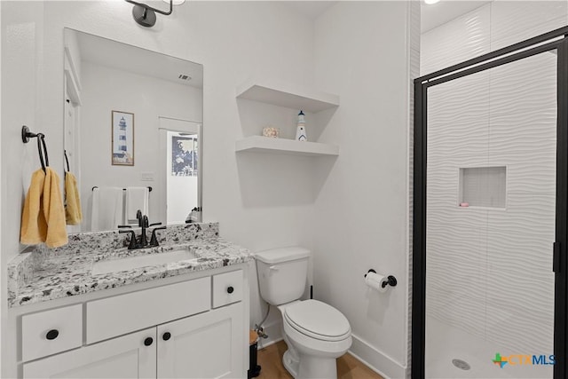 bathroom featuring toilet, visible vents, wood finished floors, a shower stall, and vanity