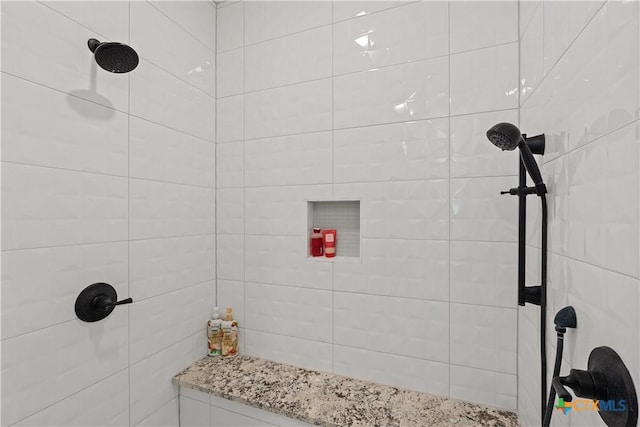full bath featuring a tile shower