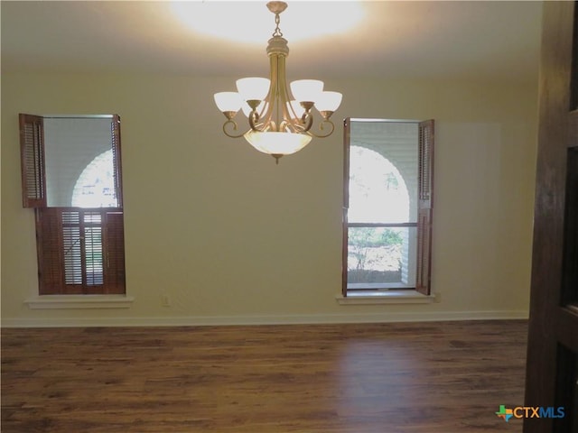 213 Tracy Ln, Victoria, TX 77904 - unfurnished room with a chandelier, plenty of natural light, and wood finished floors