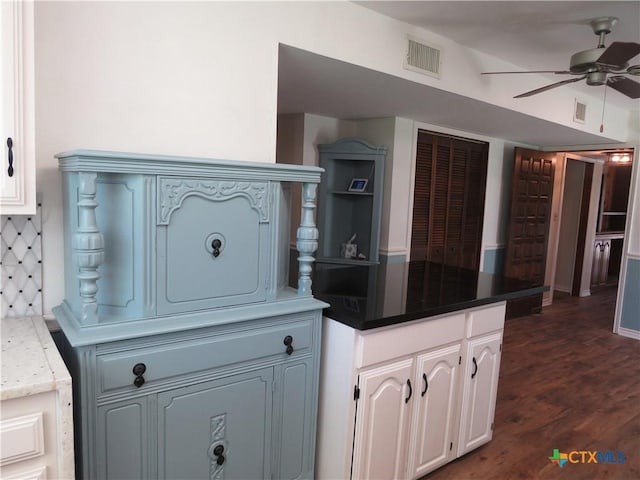 213 Tracy Ln, Victoria, TX 77904 - kitchen featuring a ceiling fan, white cabinets, dark wood finished floors, and a peninsula