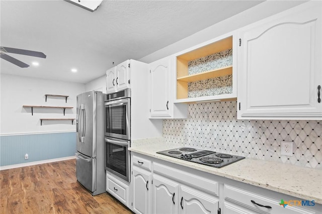 213 Tracy Ln, Victoria, TX 77904 - kitchen featuring stainless steel appliances, open shelves, wood finished floors, ceiling fan, and white cabinetry