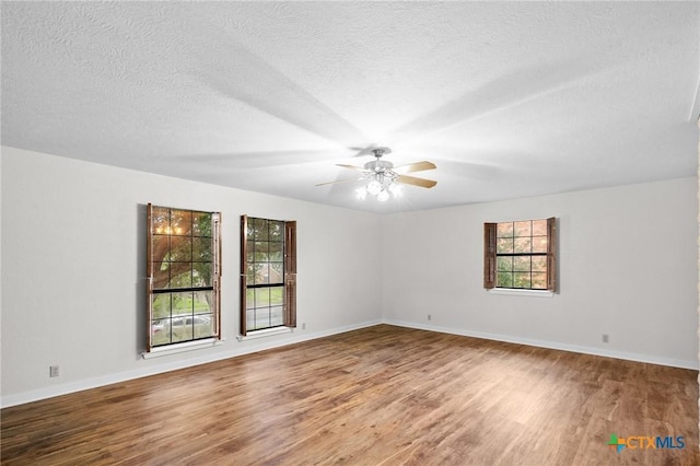 213 Tracy Ln, Victoria, TX 77904 - unfurnished room featuring wood finished floors, a ceiling fan, and a textured ceiling