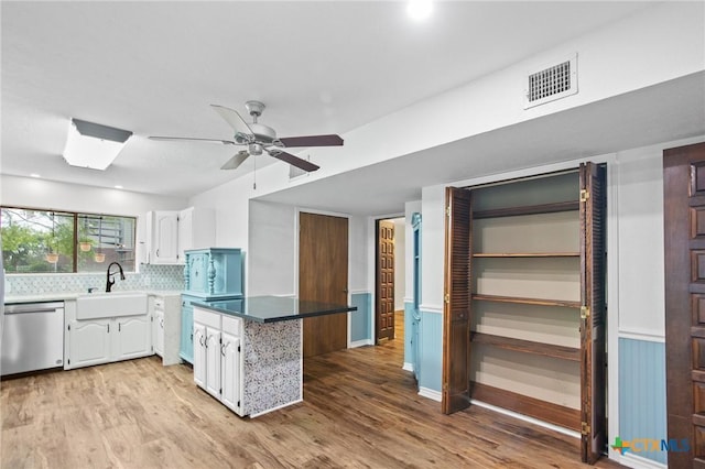 213 Tracy Ln, Victoria, TX 77904 - kitchen featuring dishwasher, white cabinets, light wood-style flooring, ceiling fan, and backsplash